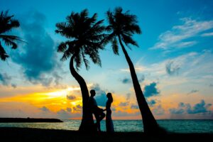 Couple holding hands on a beach.